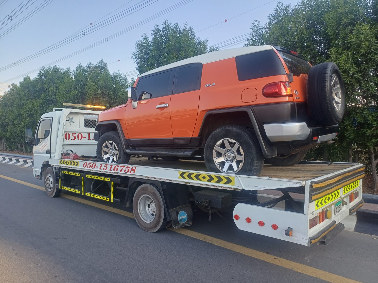 White Pickup with Camper towing